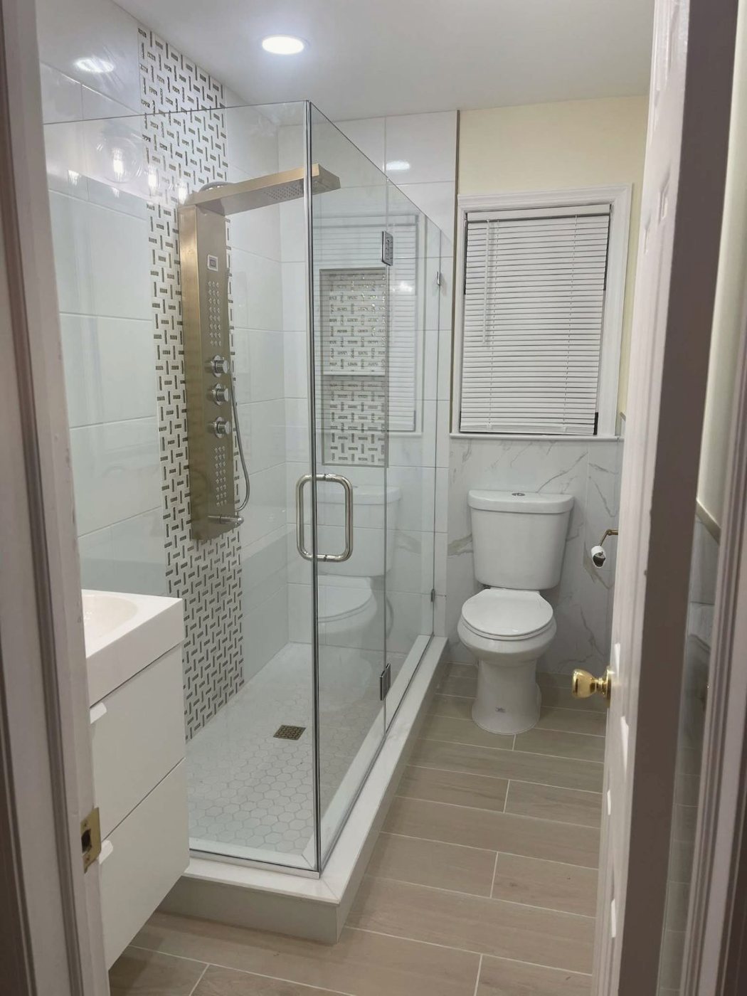 Glass shower with mosaic accent strip