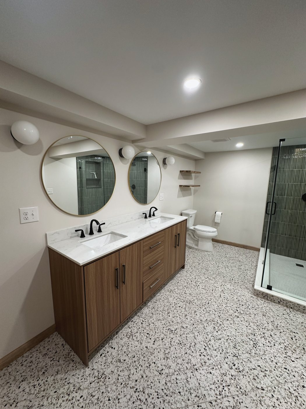 Basement bathroom with glass shower and terrazzo floor
