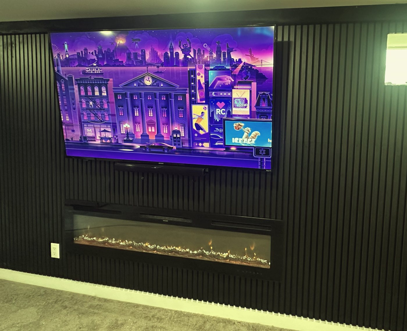 Black slat media wall with TV and linear fireplace